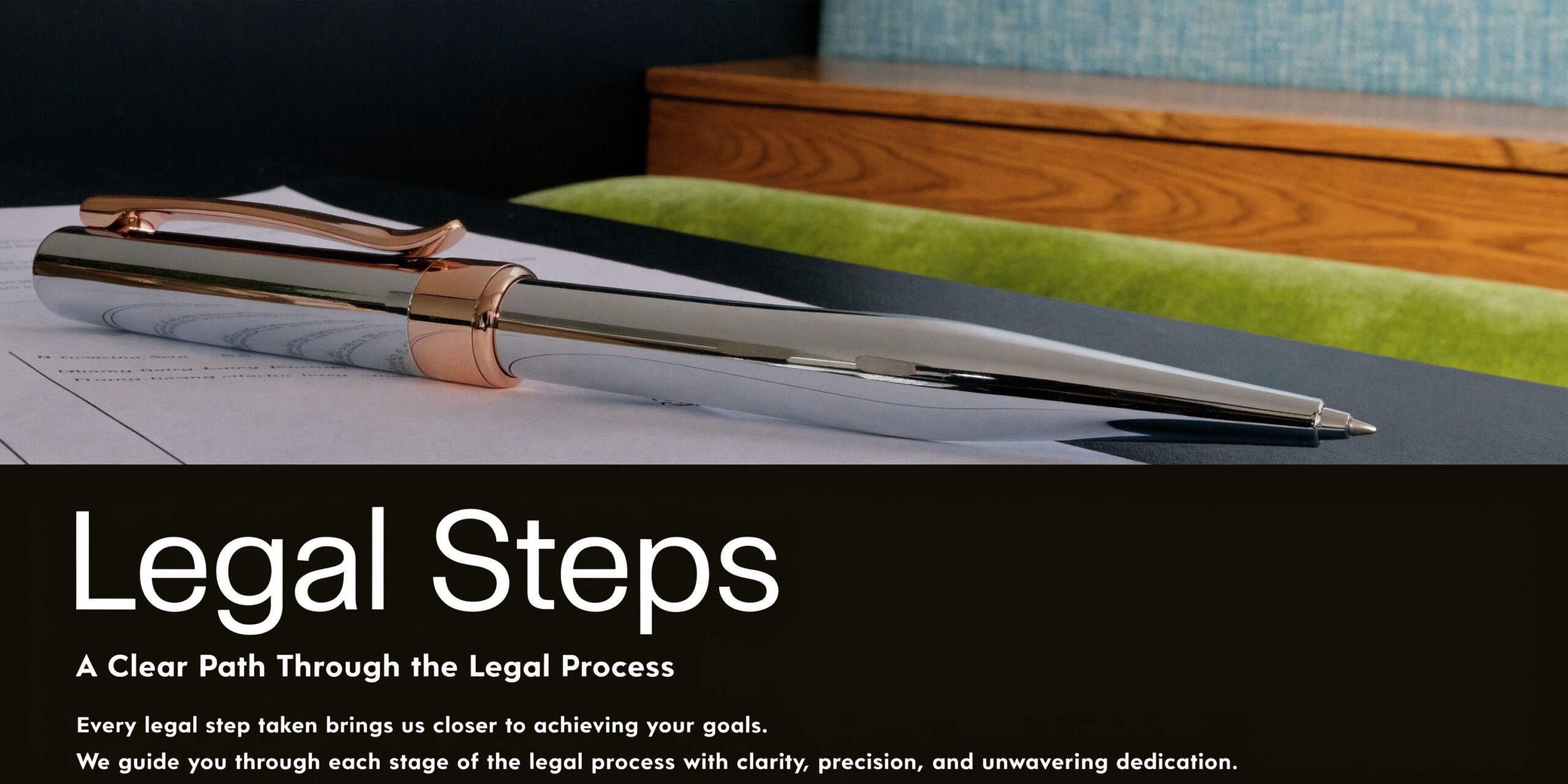 A sleek silver and rose gold pen resting on top of a legal document.