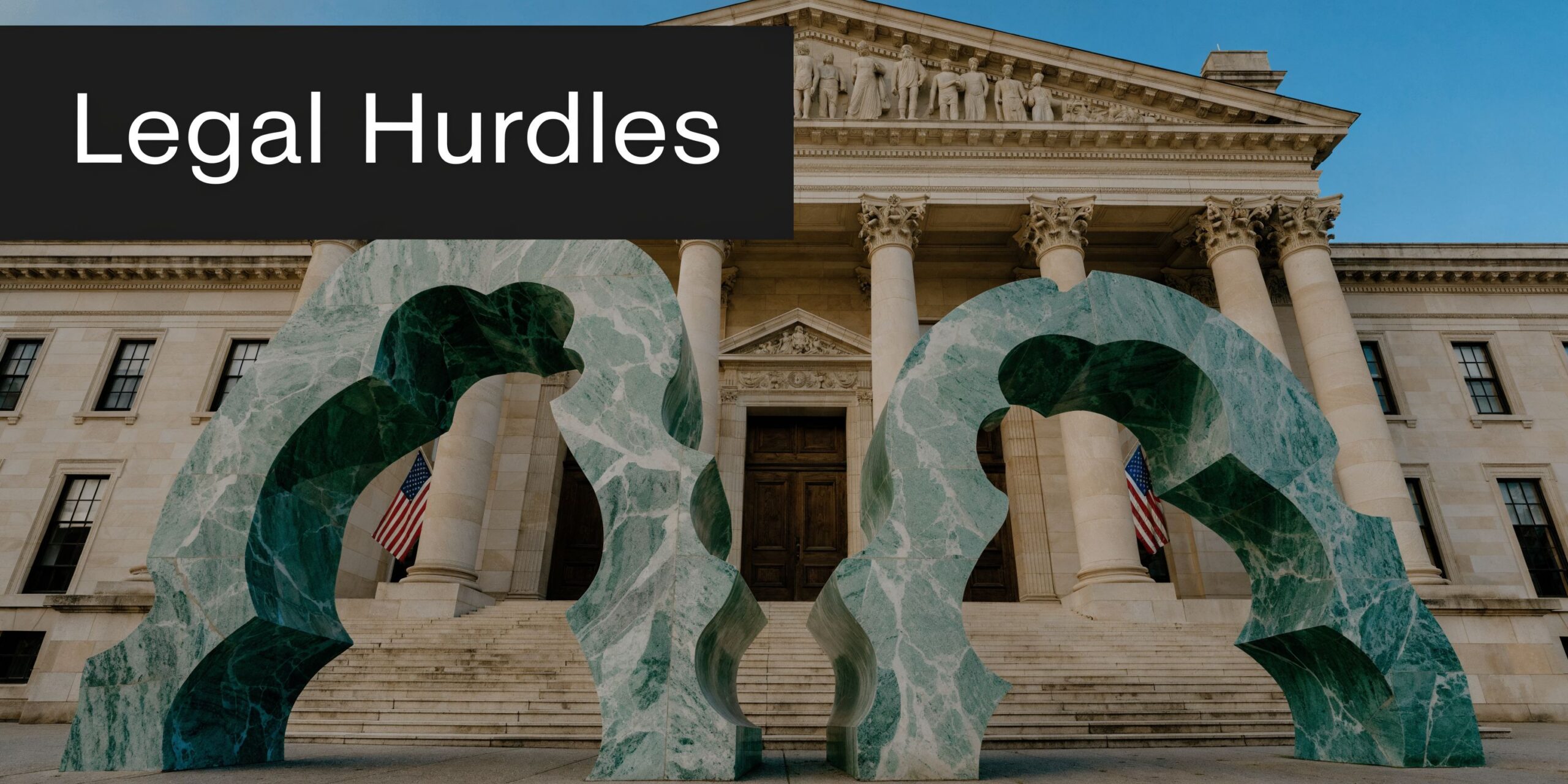 A grand government building with stone columns featuring large green marble sculptural arches in the foreground.