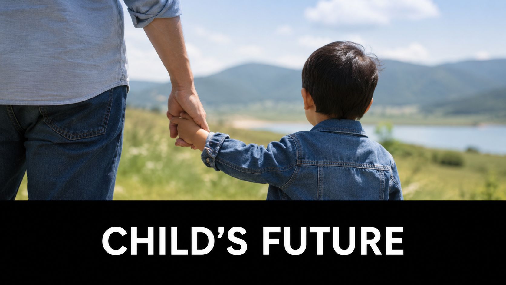 A father and son holding hands looking out over a scenic lake and mountains together.